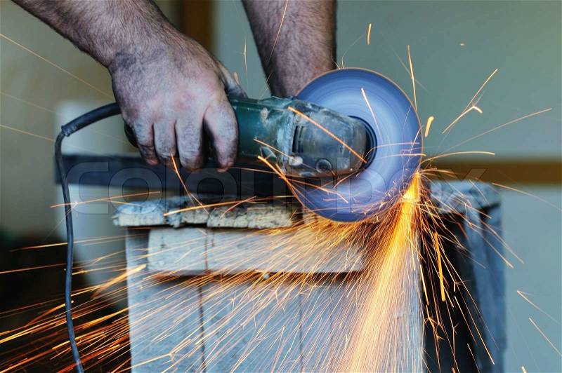 Industry worker cut steel with spinning machine and spark, stock photo