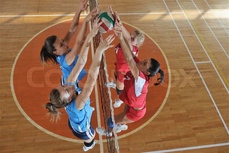 Volleyball game sport with group of young beautiful girls indoor in sport arena, stock photo