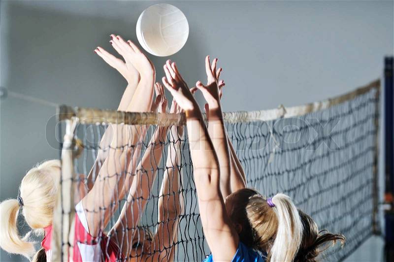 Volleyball game sport with group of girls indoor in sport arena, stock photo