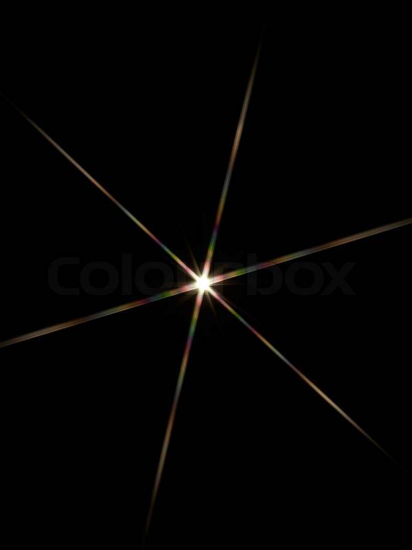 Colorful glaring light star in black back, stock photo