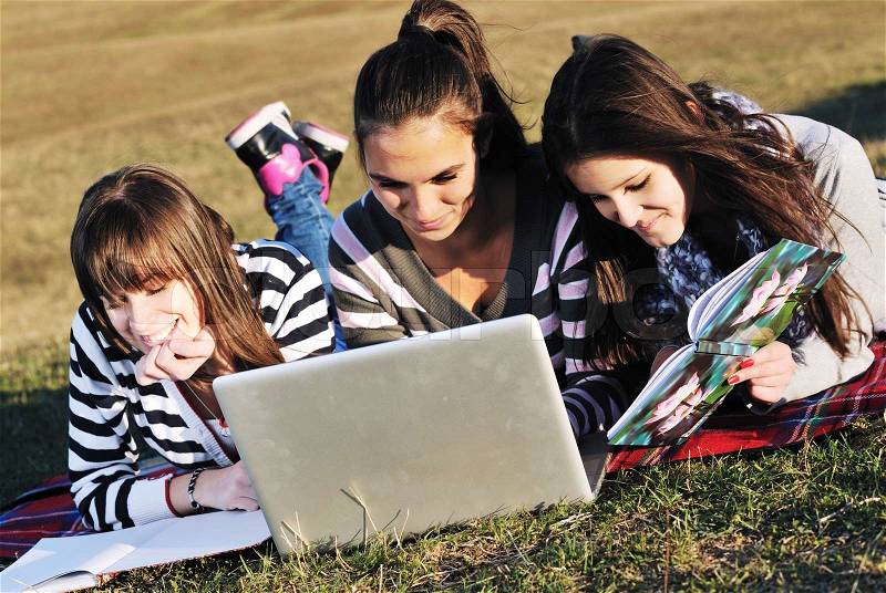 Group of teen girl woman outdoor have fun and study homework on laptop computer, stock photo