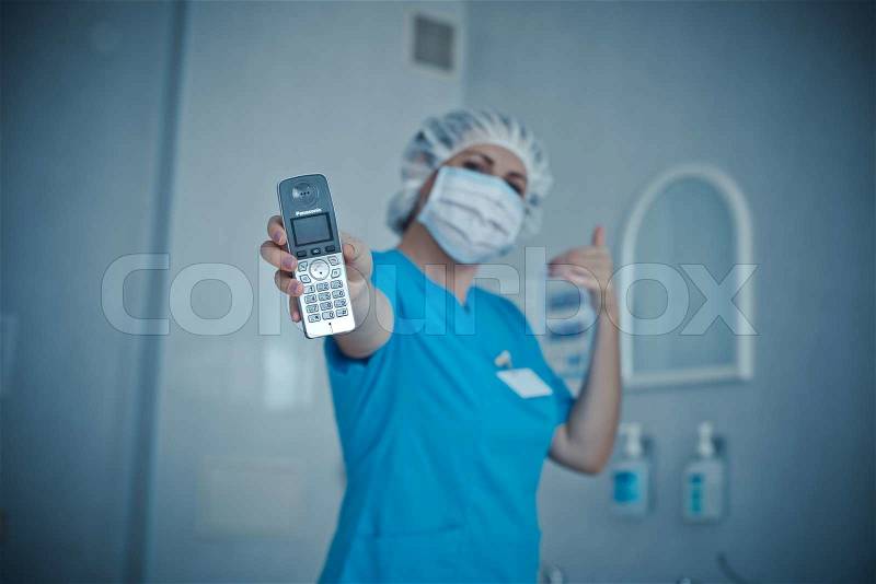 Nurse talking on a cell in the hospitalnurse talking on a cell in the hospital, stock photo