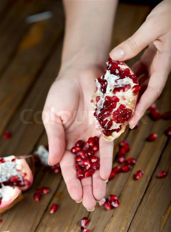 Pomegranate fruit on the table, sliced pomegranate on a plate, peel a pomegranate,, stock photo