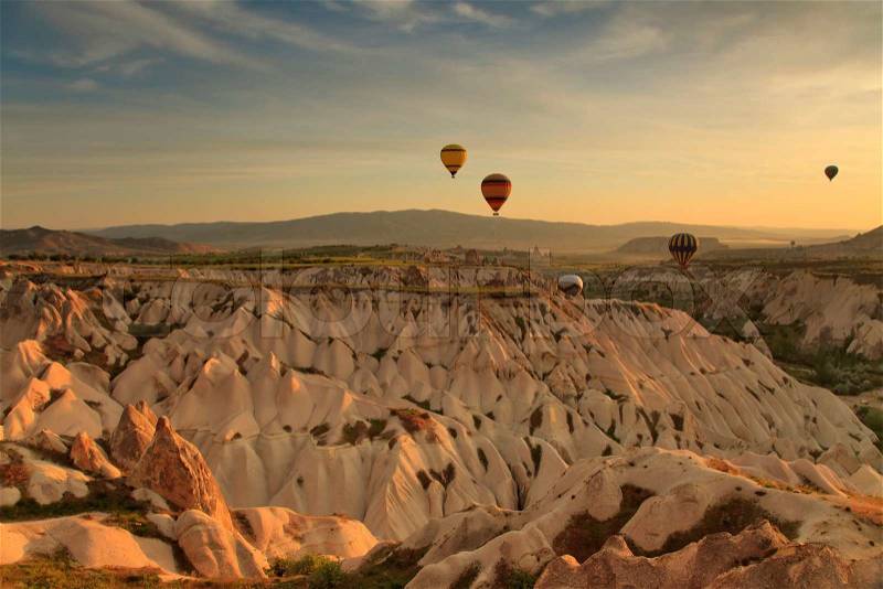 Hot air balloon flying over rock landscape at Cappadocia Turkey, stock photo