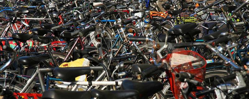 Hundreds of bikes parked on the sidewalk in Amsterdam, stock photo