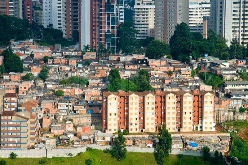 Scenic view of shanty town contrasting with skyscrapers in background, Morumbi neighborhood, Sao Paulo, Brazil, stock photo