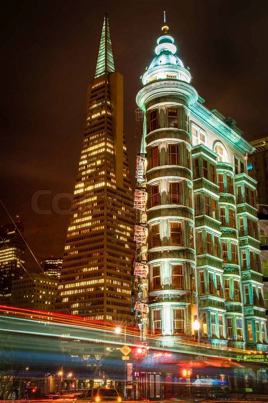 Buildings lit up at night in a city, Columbus Tower, Transamerica Pyramid, San Francisco, California, USA, stock photo