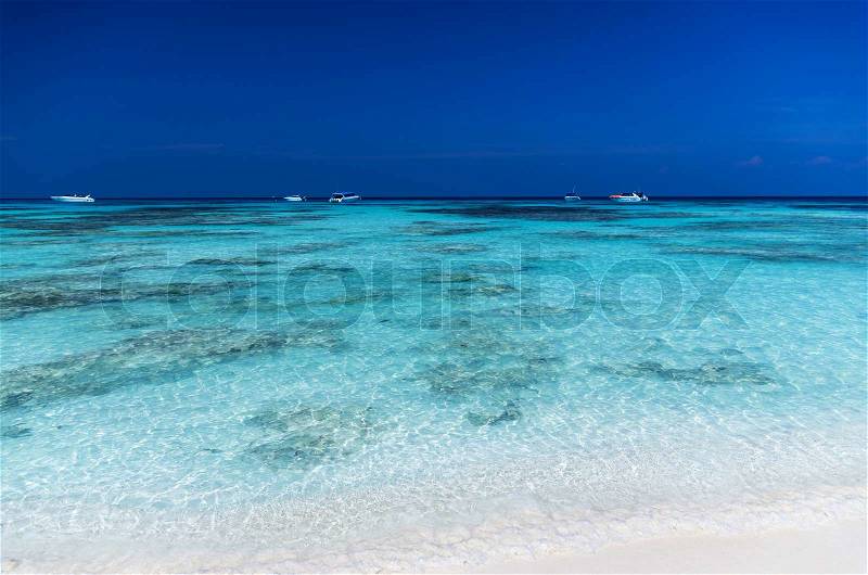 White seabeach with blue sea and sky, speed boat, sea beach background, stock photo