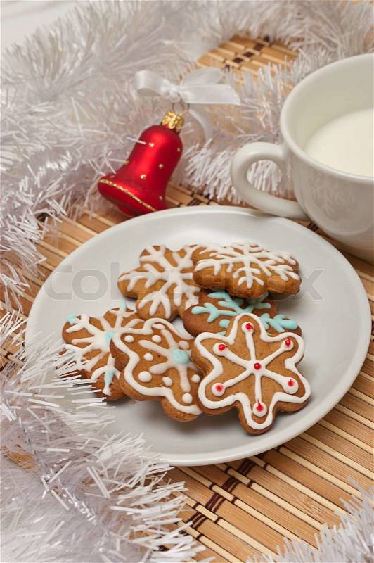 Decorated Sugar Cookies and Milk for Santa at Christmas Time on a table with decoration, stock photo