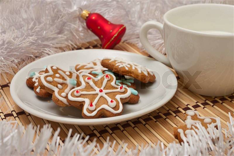 Decorated Sugar Cookies and Milk for Santa at Christmas Time on a table with decoration, stock photo
