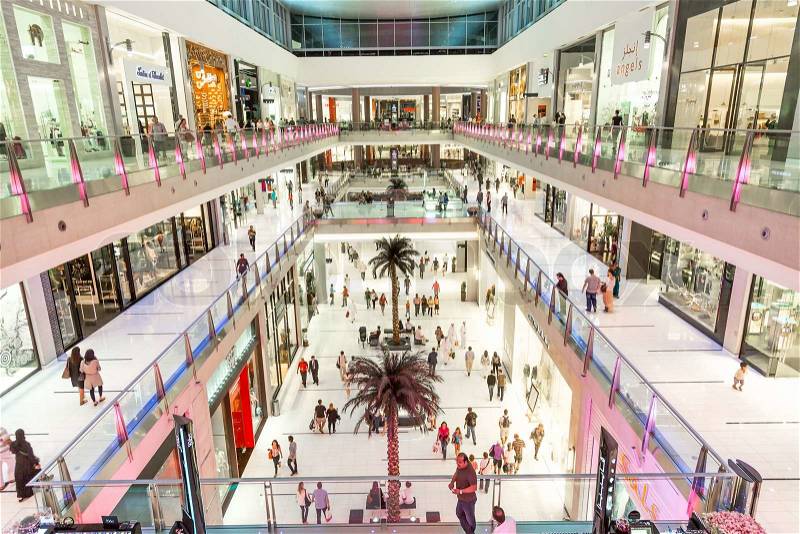 DUBAI, UAE - NOVEMBER 14: Shoppers at Dubai Mall on Nov 15, 2013 in Dubai. At over 12 million sq ft, it is the world's largest shopping mall, stock photo