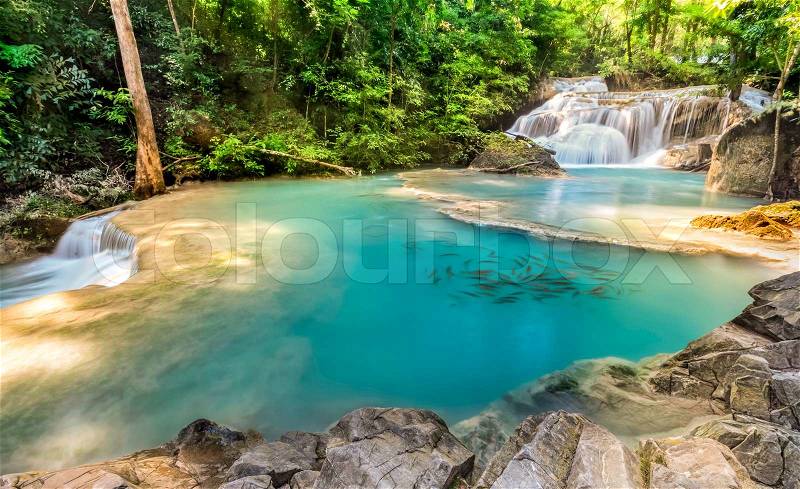 First level of Erawan Waterfall in Kanchanaburi Province, Thailand with fish, stock photo