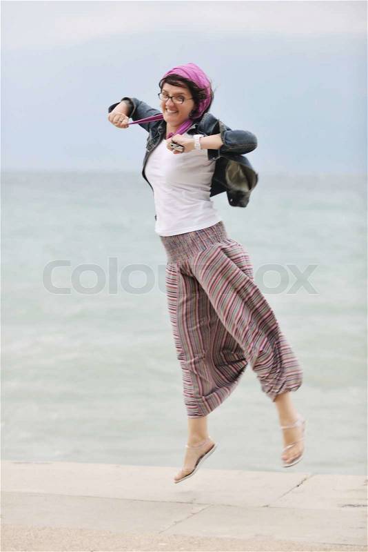 Beautiful young woman on beach with scarf relax smile and have fun, stock photo