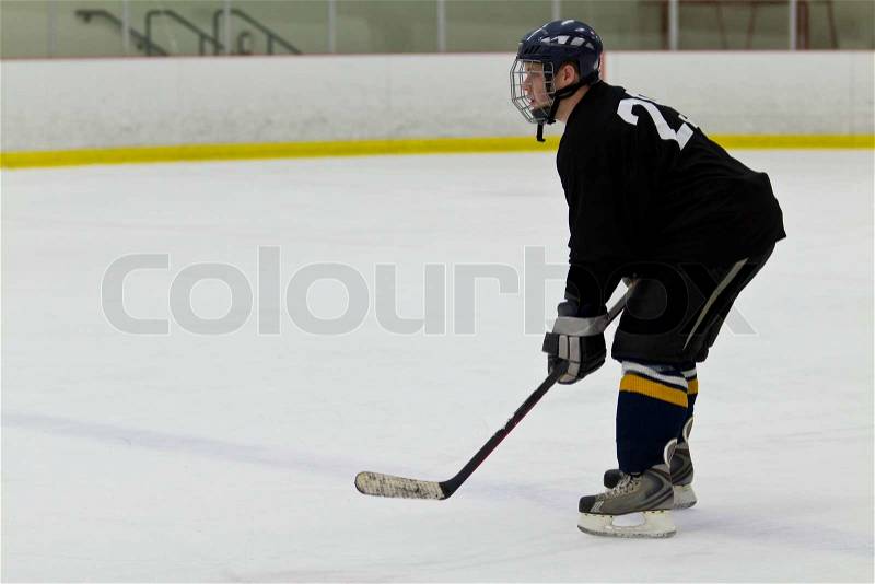 Hockey player patrolling the blue line, stock photo