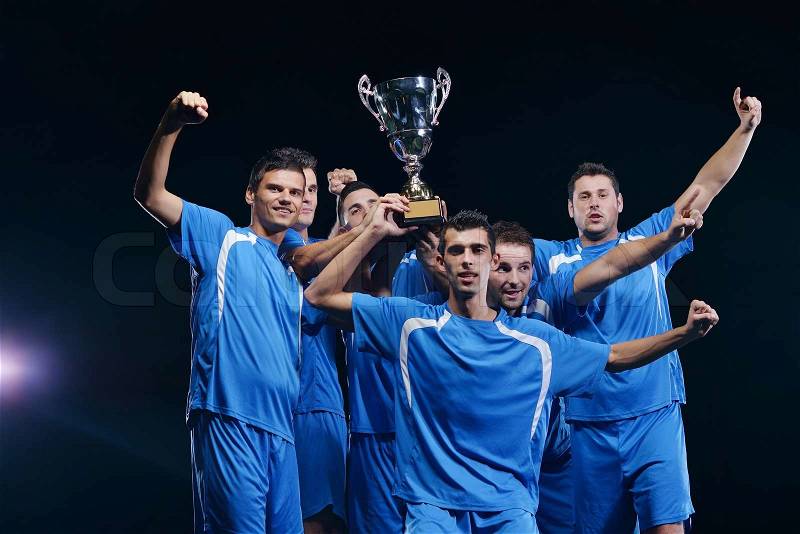 Soccer players team group celebrating the victory and become champion of game while holding win coup, stock photo