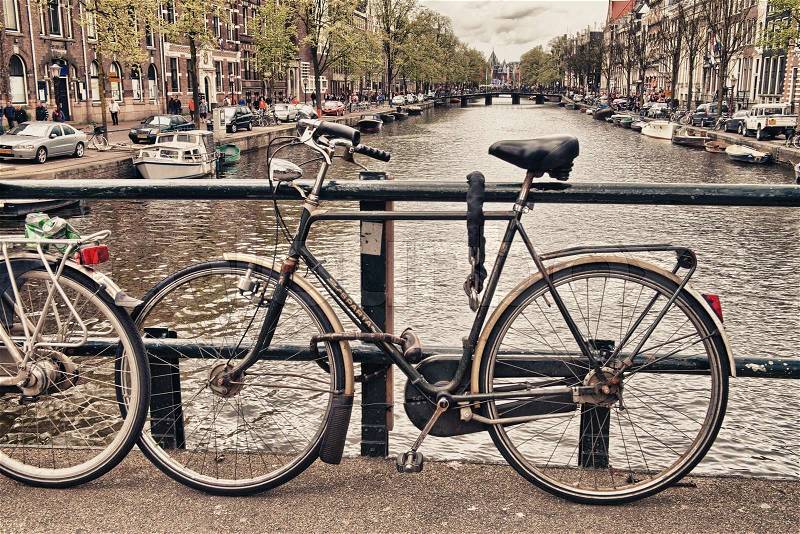 Amsterdam, Netherlands. Bicycle over city channels, typical street scene, stock photo