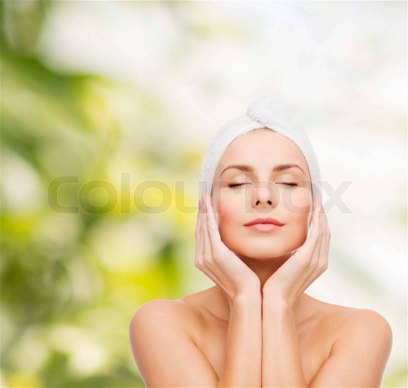 Health, spa and beauty concept - beautiful woman in towel, stock photo