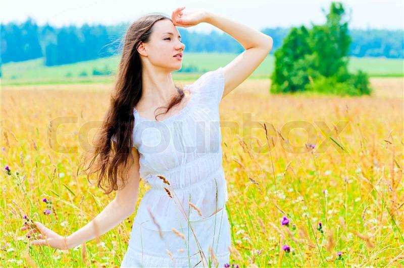 Slender beautiful girl in flower field , stock photo