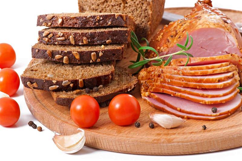 Ham, bread and spices on wooden board, stock photo