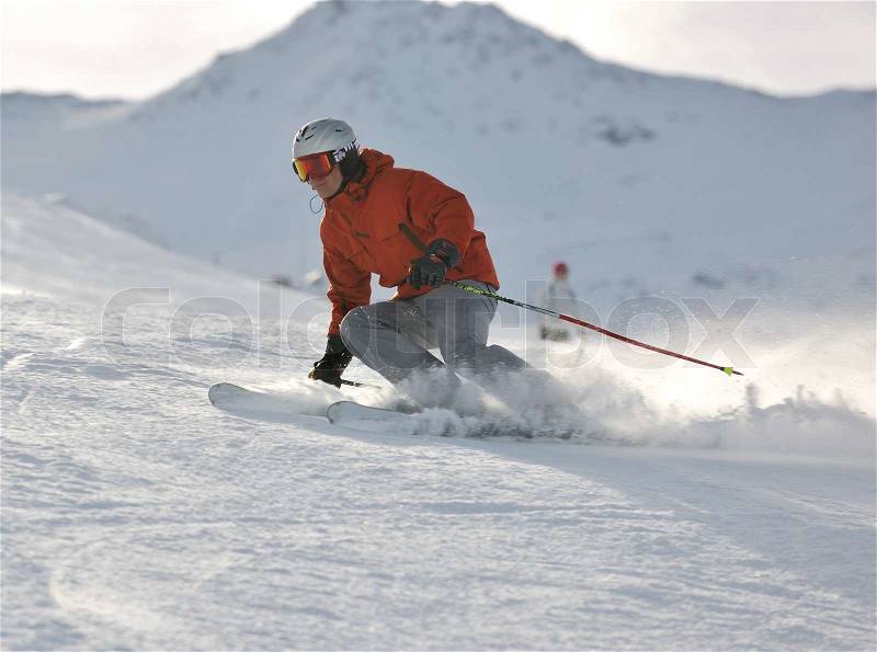 Young athlete man have fun during skiing sport on hi mountain slopes at winter seasson and sunny day, stock photo