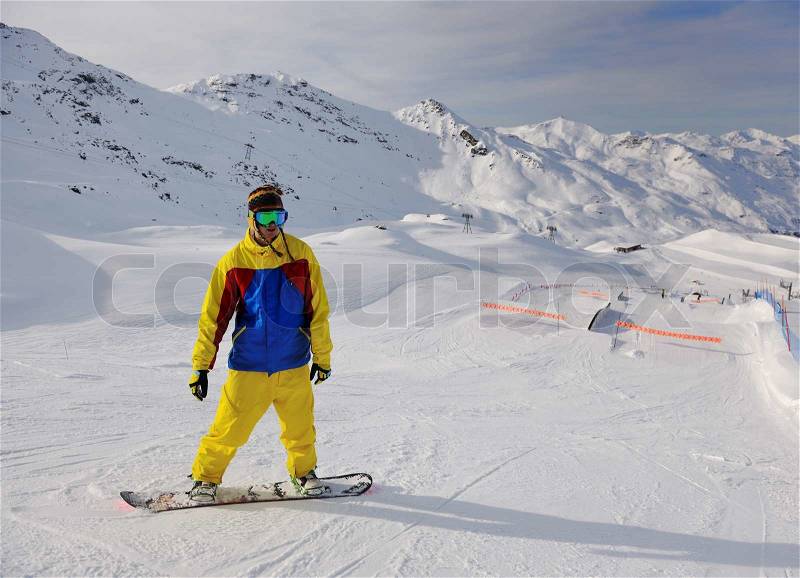 Happy young man have fan while relaxing at snow with ski and snowboard sport at winter season, stock photo