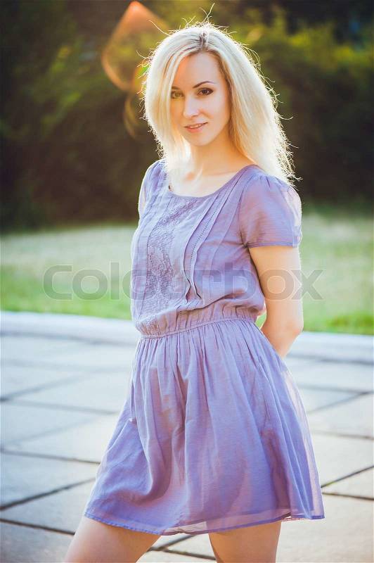 Portrait of young girl outdoors with sunbeams, stock photo