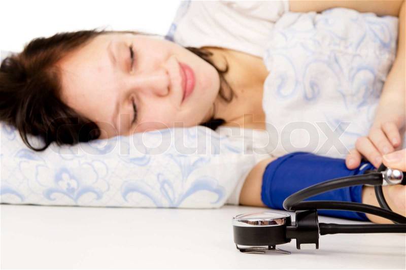 The diseased girl lying on the bed, and measure the pressure isolated on white background, stock photo
