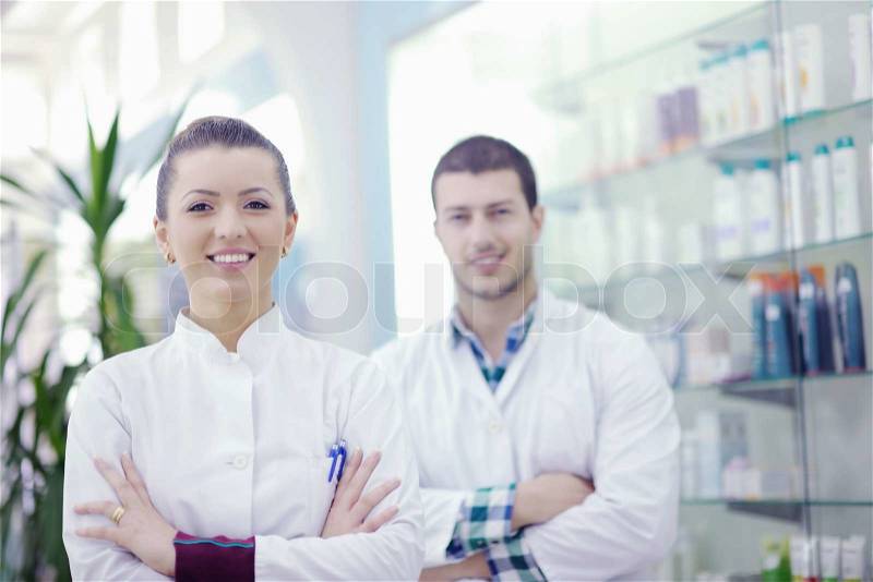 Team of pharmacist chemist woman and man group standing in pharmacy drugstore, stock photo