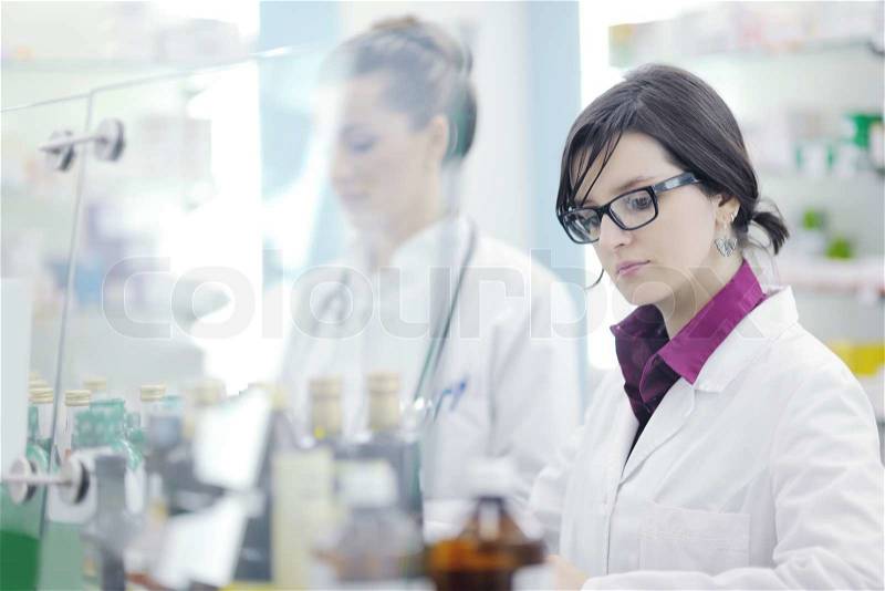 Team of pharmacist chemist woman group standing in pharmacy drugstore, stock photo