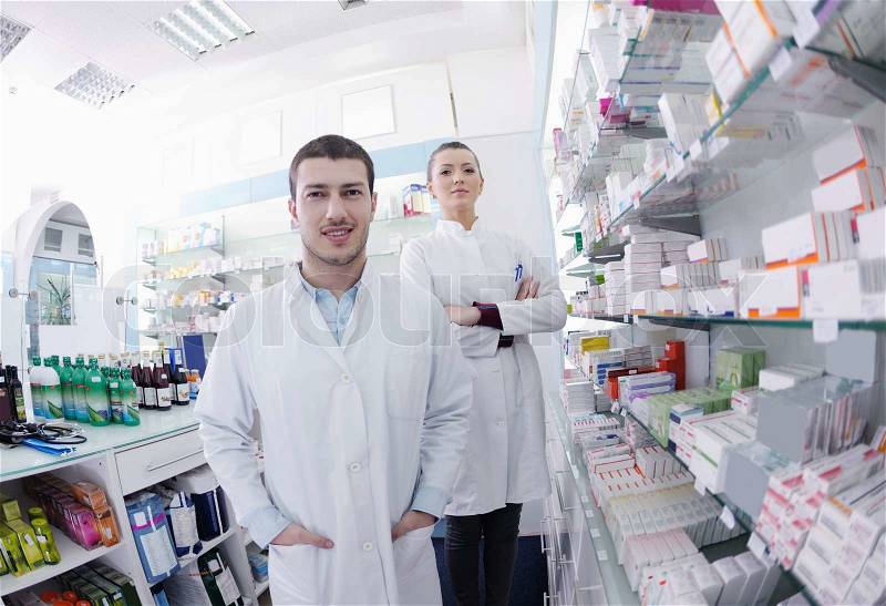 Team of pharmacist chemist woman and man group standing in pharmacy drugstore, stock photo