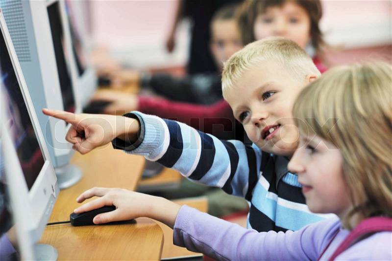 It education with children group in school at computer science class learning leassons and practice typing , stock photo