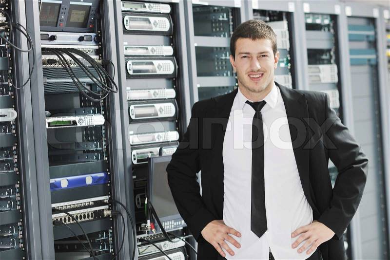 Young handsome business man it engeneer in datacenter server room, stock photo