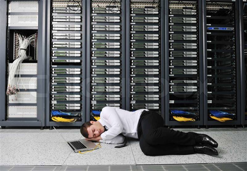 Business man in network server room have problems and looking for disaster solution, stock photo