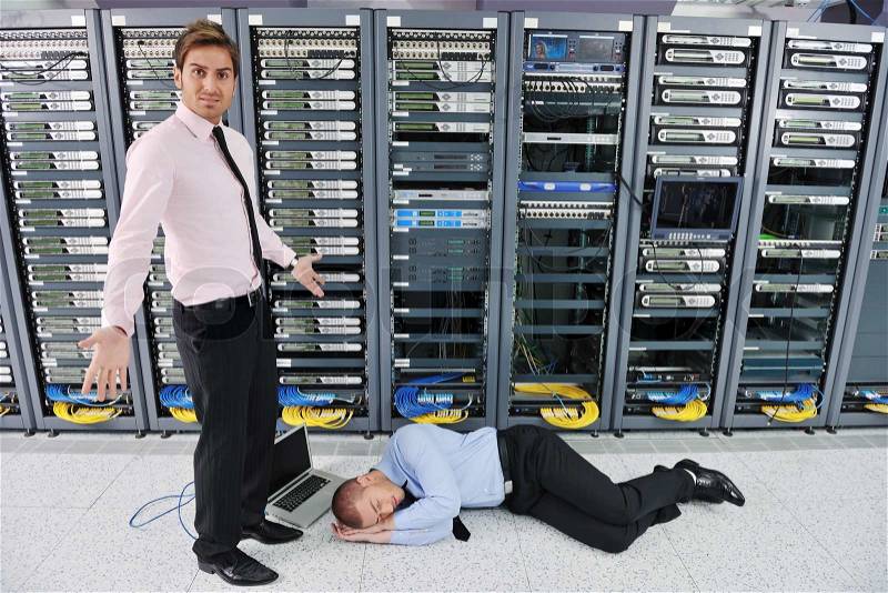 It business man in network server room have problems and looking for disaster situation solution, stock photo
