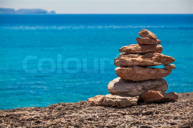 Stack of stones on the beach and sea background. Set stones to relax with the sea in background. Set stones to relax with the sea in background, stock photo