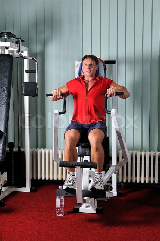 Strong young man work out in gym, stock photo