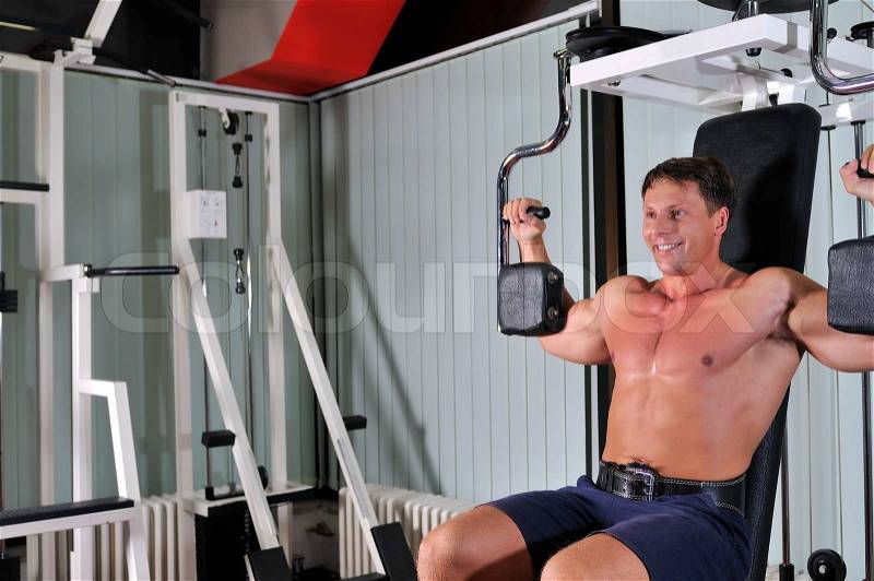 Strong young man work out in gym, stock photo