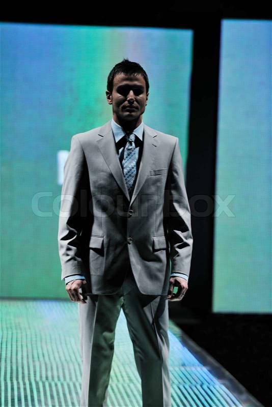 Handsome man male model at fashion show stage event, stock photo