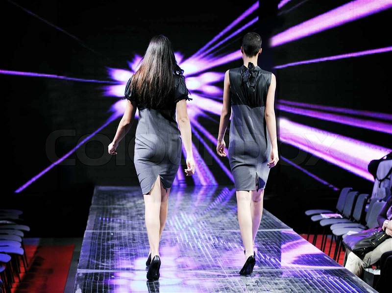 Beautiful young fashion model woman walking on fashion show event , stock photo