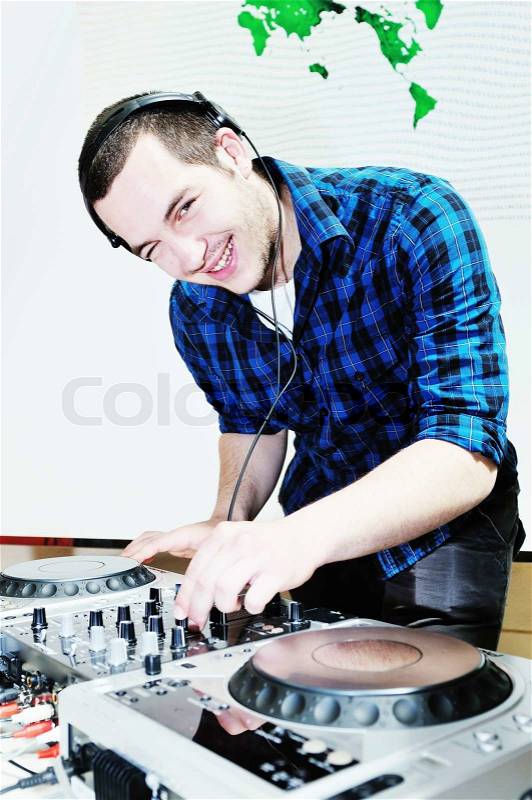 Young dj man with headphones and compact disc dj equipment on party, stock photo