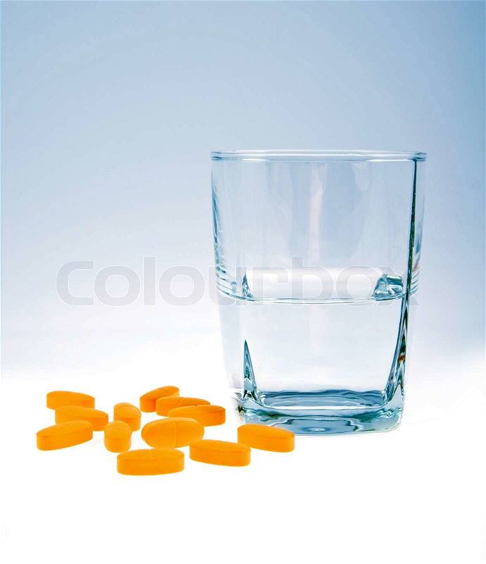 Vitamins with glass of water isolated, stock photo