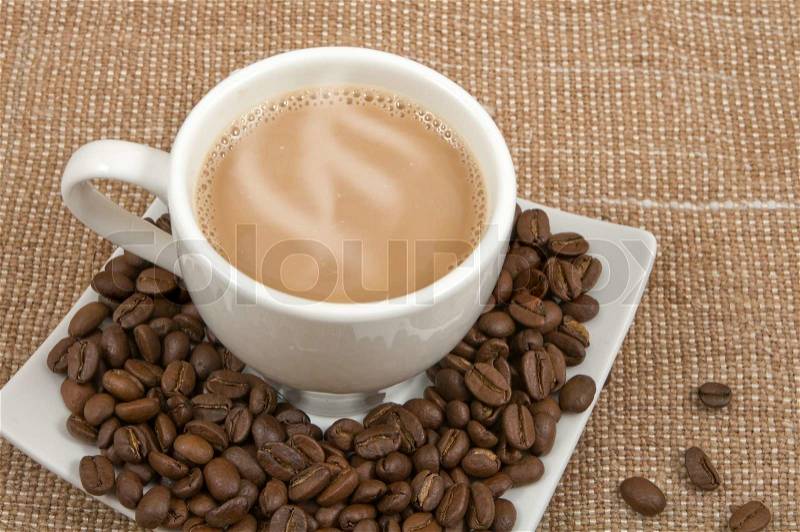 Coffee and milk and saucer with grains on a background sacking, stock photo