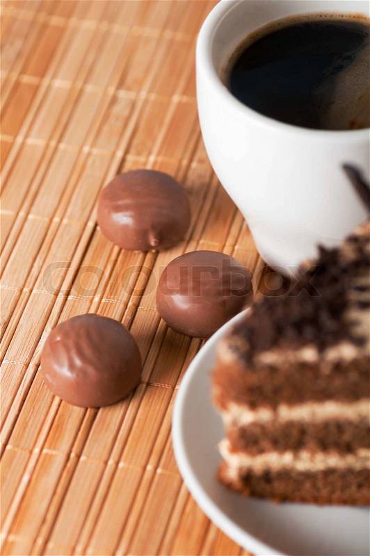Three chocolates ,a black coffee and a piece of cake, stock photo