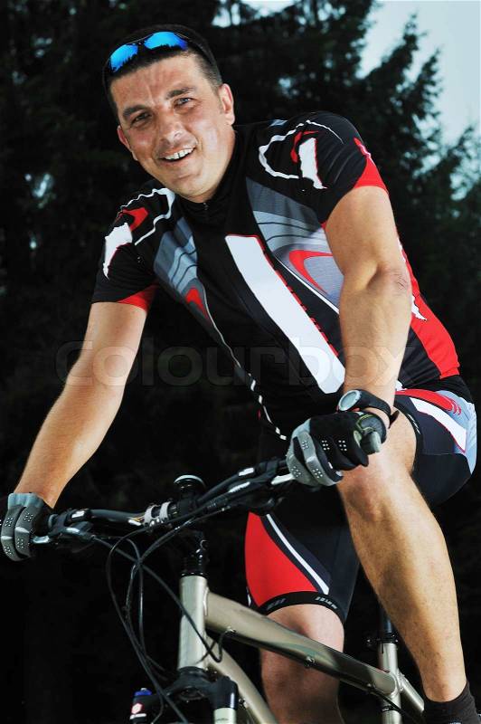 Healthy lifestyle and fitness concept with mount bike man who ride bike outdoor, stock photo