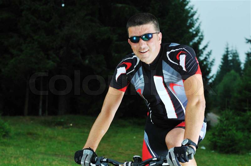 Healthy lifestyle and fitness concept with mount bike man who ride bike outdoor, stock photo