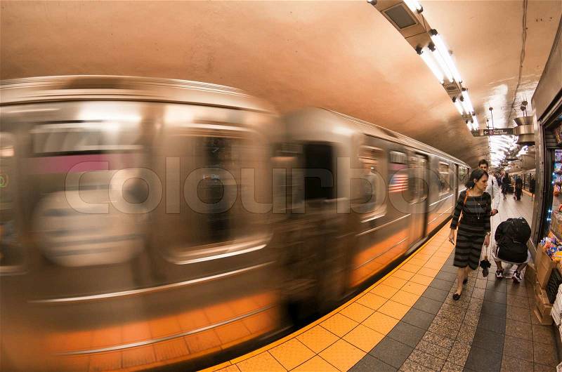 NEW YORK CITY - MAY 23, 2013: Train speeds up in a subway station of New York. Owned by the NY City Transit Authority, the subway has 469 stations in operation, stock photo