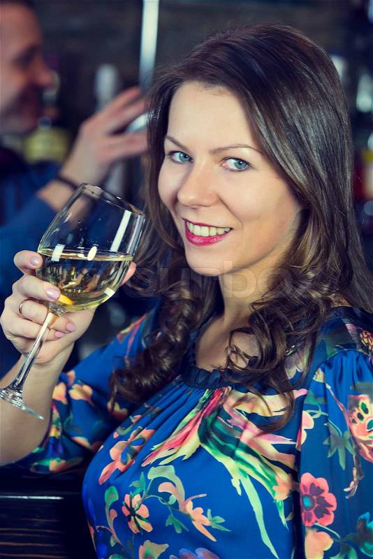 Young girl in the bar drinking wine, stock photo