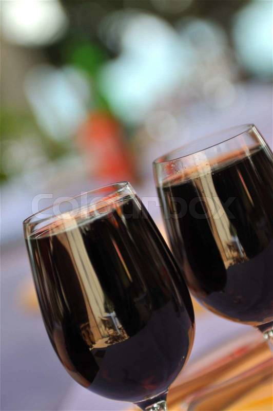 Two glasses in outside restaurant with black wine, stock photo