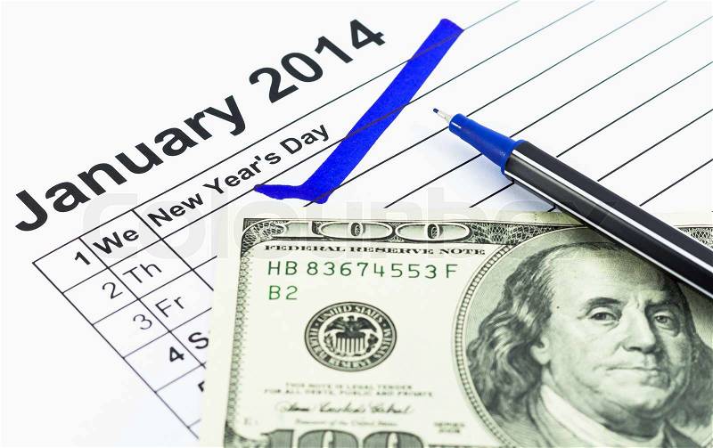Blue check. Mark on the calendar at 1St January 2014 with usd money, new year\'s day, stock photo