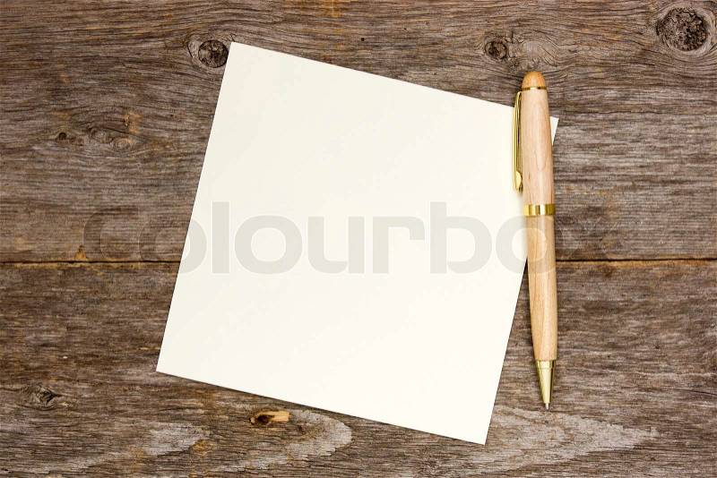 Empty note paper with pen on the wooden background, stock photo